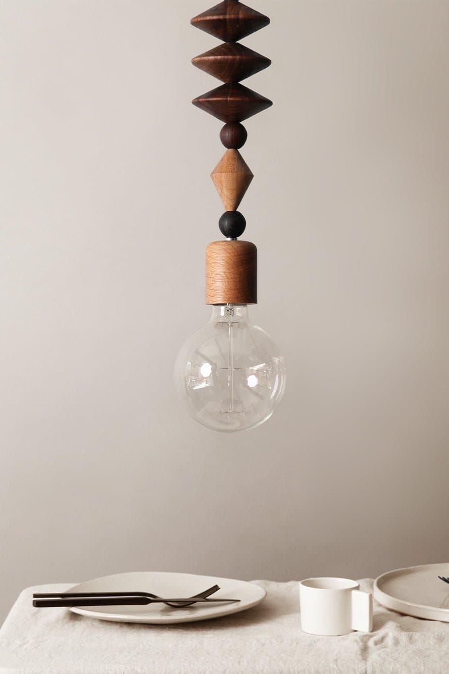 Marz Designs - Bright Beads Art Pendant Light above a table.