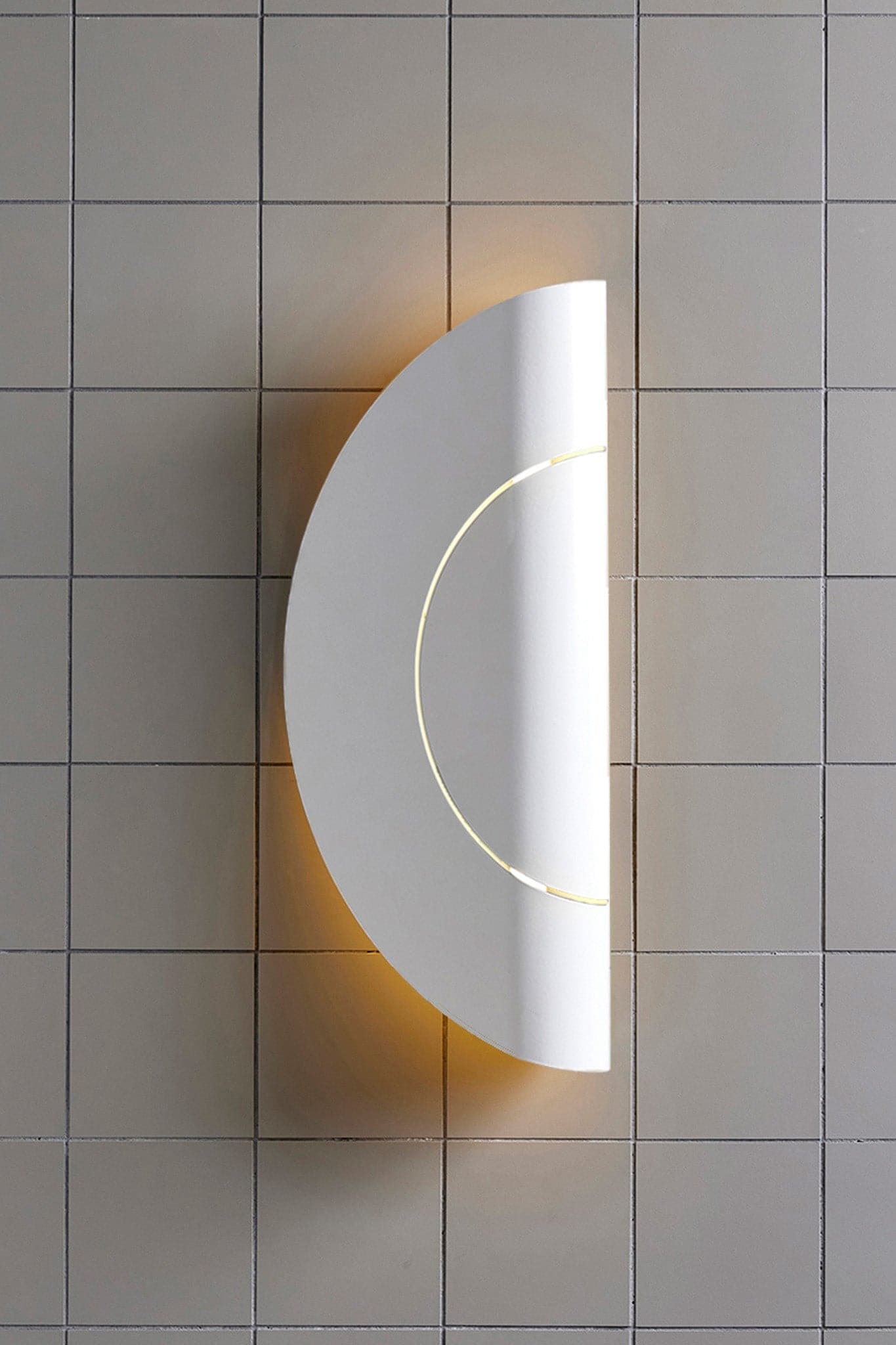 Marz Designs Feature Lighting - Furl Circle Wall Light in White Powder Coat with the light on.