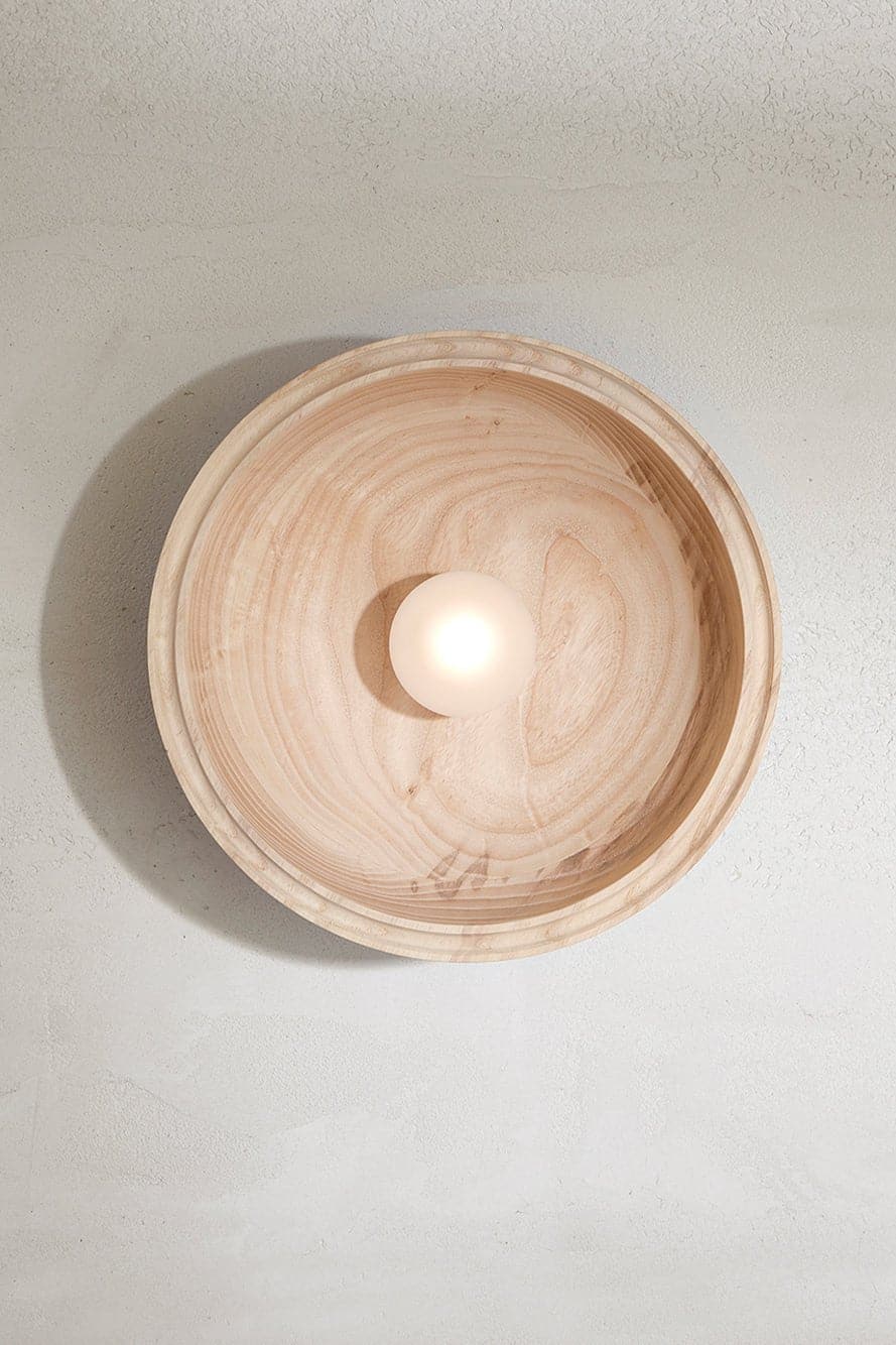 Marz Designs - Selene Surface Sconce Large in Ash with the light on.