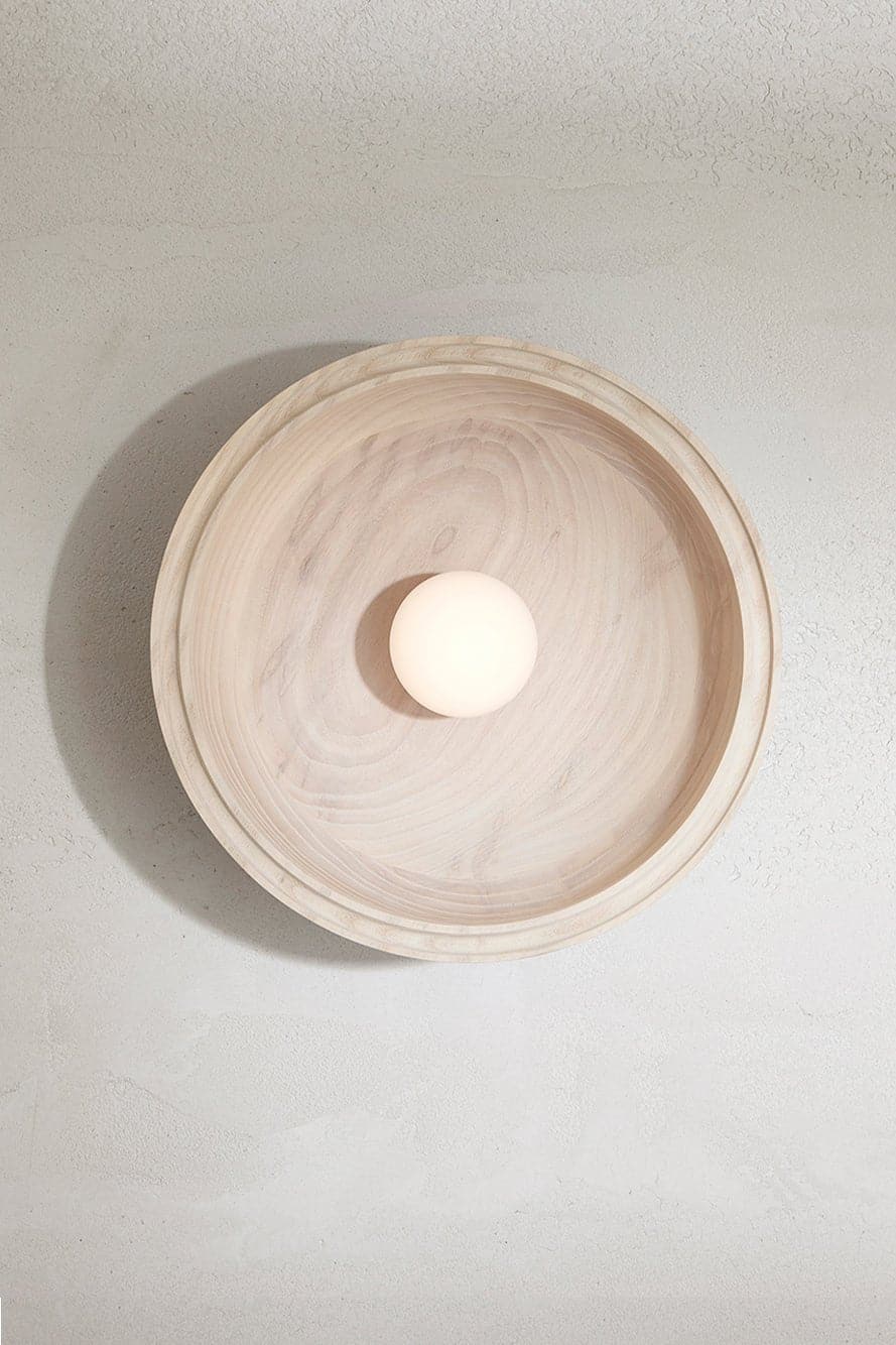 Marz Designs - Selene Surface Sconce Large in Bleached Ash with the light on.