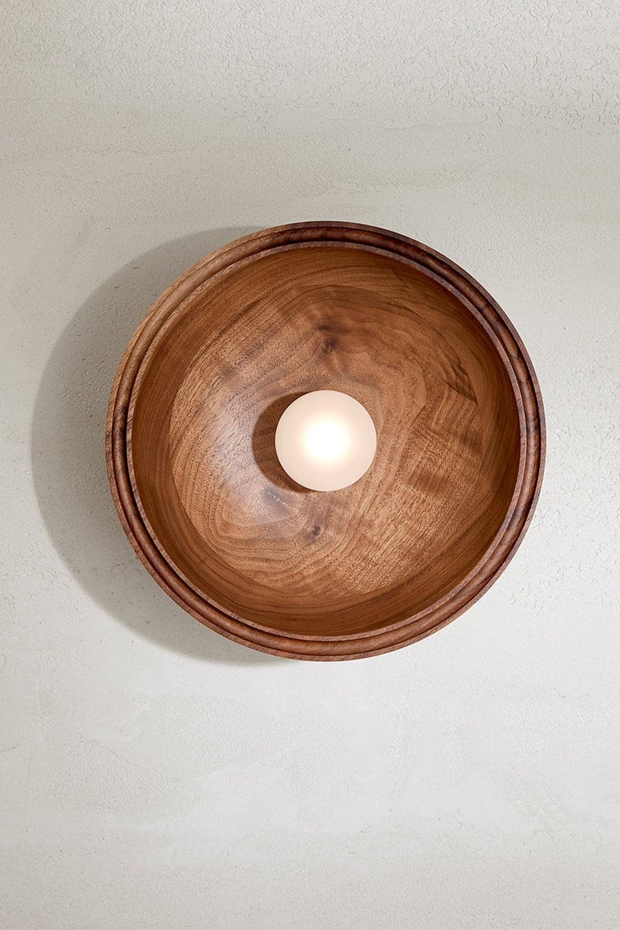 Marz Designs - Selene Surface Sconce Large in Walnut with the light on.